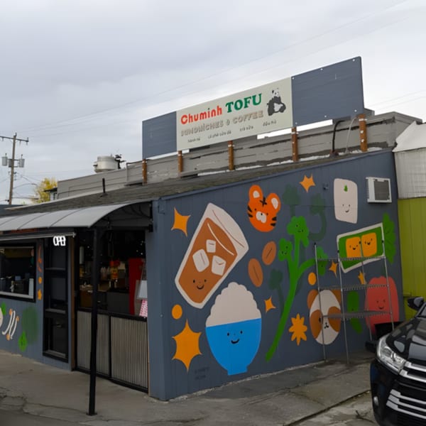 ChuMinh Tofu restaurant exterior with a colorful mural of food and a panda logo sign.