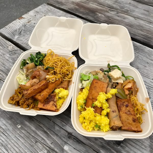 Two ChuMinh Tofu takeout containers filled with Vietnamese dishes, including tofu, noodles, and rice.
