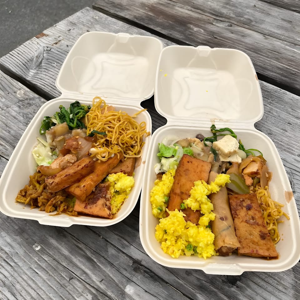 Two ChuMinh Tofu takeout containers filled with Vietnamese dishes, including tofu, noodles, and rice.